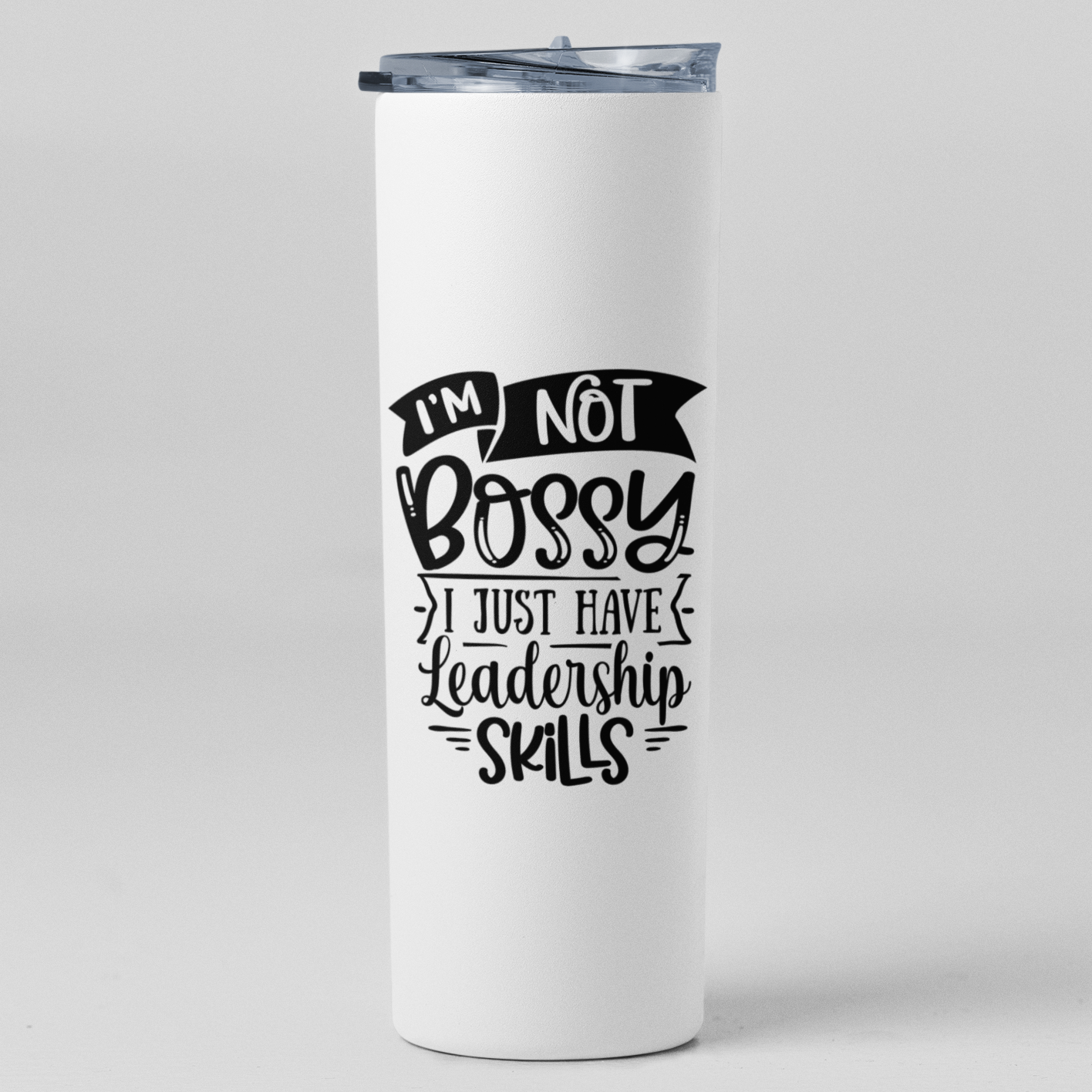 A white 20oz tall skinny tumbler with black witing that says I'm not bossy I just have leadership skills