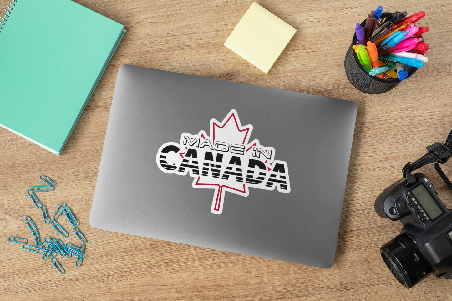 a Canadian maple leaf sticker that says made in Canada on a lap top sitting on a desk