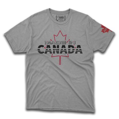 A grey t-shirt with a Canadian maple leaf on the front chest that says made in Canada and a maple leaf on the left sleeve with the word patriot